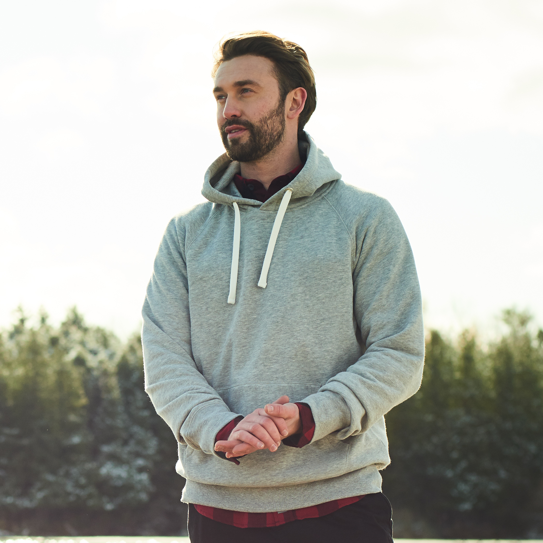 Male model with grey hoodie on.